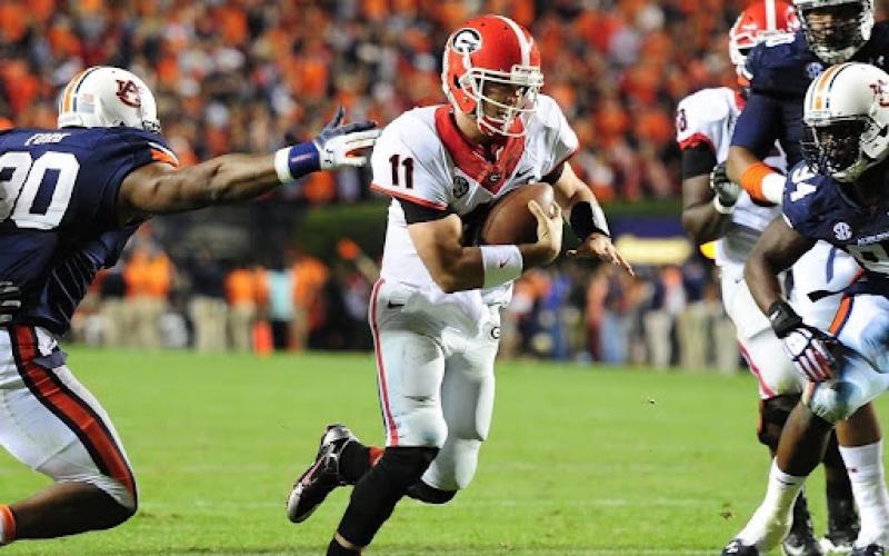 Photo via @aaronmurray11 on Instagram. Former Georgia quarterback Aaron Murray runs away from an Auburn defender during his Bulldog playing career. Murray was a four-year starter for the Bulldogs from 2010-2013 after redshirting in 2009. He is still the SEC’s all-time leading passer, throwing for 13,166 yards in his career.