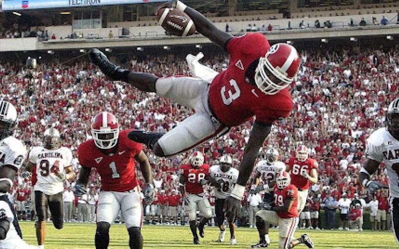 Photo courtesy of DJ Shockley. Former UGA quarterback DJ Shockley goes airborne on a run versus South Carolina during his playing days. Shockley, now a sports anchor with Fox 5 Atlanta, was Georgia’s starter in 2005.