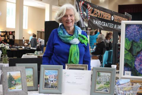 Diane Rush displays her certificate for winning "Peoples Choice Award" for her paintings of historic buildings of Rabun County at the Painted Fern Festival of Art hosted by the North Georgia Arts Guild at the Rabun County Civic Center on July 13-14.