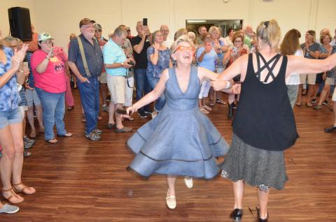 Wayne Knuckles/The Clayton Tribune. Cyndae Arrendale of Clarkesville twirls across the dance floor Saturday in Mountain City. The event was part of Rabun County's 200th birthday celebration. 