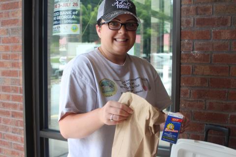 Rabun County Family Connections employee Alora Burt passes out meals to children at the Food Bank of Northeast Georgia in Clayton on Monday as part of the United States Department of Agriculture Summer Food Service Program.