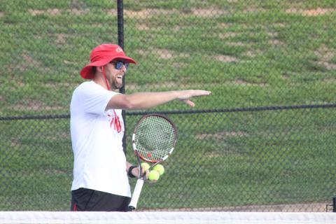 Rabun County tennis coach Bryan Getty instructs players during the Wildcat Tennis Academy at Rabun County High School’s tennis courts Monday night. (Glendon Poe/The Clayton Tribune)