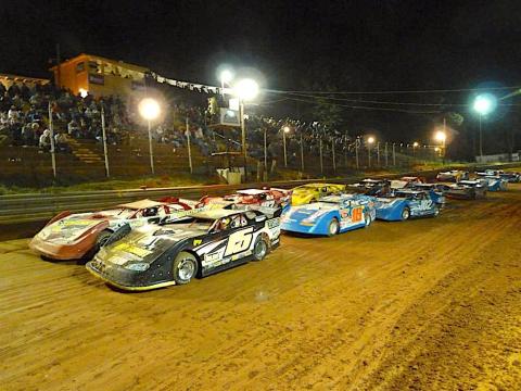 Cars running two across roar down the straightaway during a feature race at Toccoa Raceway.Photo racingin.com