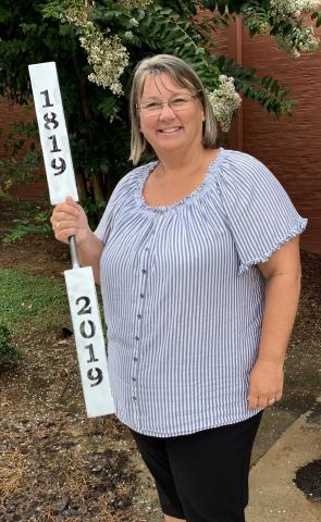 Teka Earnhardt holds the ceremonial torch that will be carried through the streets of Clayton Saturday as part of Rabun County's 200th birthday celebration.