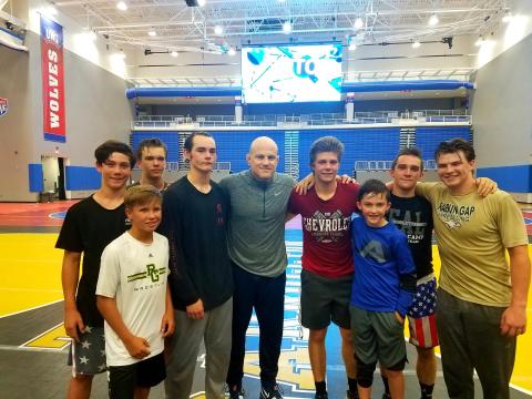Nolan Conrad of Clayton, Charlie Hall of Long Creek, S.C., Aiden McMullen of Highlands, N.C., Cole Owens of Conyers, Cael Sanderson (Penn State coach), Aidan Loring of Clayton, Brody Fon of Franklin, N.C., Matt Campbell of Highlands, N.C., and Quill Martin of Clayton are pictured. (Photo courtesy of Rabun Gap-Nacoochee School)