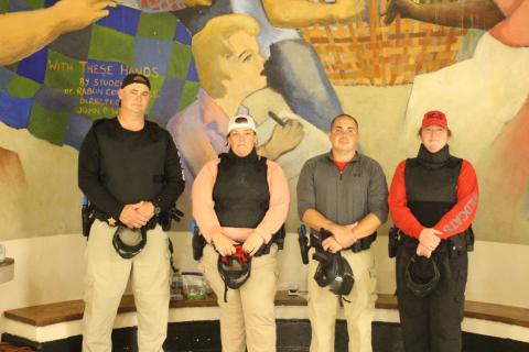 Megan Broome/The Clayton Tribune. Rabun County School Resource Officers (SROs) Sgt. Tim Brown, Deputy Beth Darnell, Deputy Chris Bartolomey and Deputy Lisa Thompson don their protective gear to train in the Heightened Emergency Response Officer (HERO) program at Rabun County Middle School on July 31 in preparation for the new school year. Lt. Mark Gerrells from the Rabun County Sheriff’s Office trains the SROs on this program.