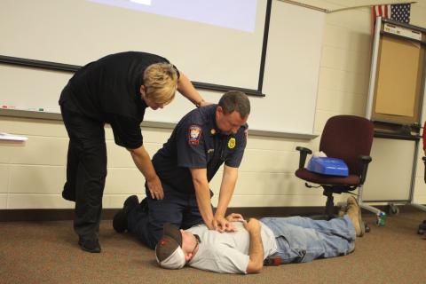 Megan Broome/The Clayton Tribune. Lt. Misty Houston, Rabun County Emergency Services, Justin Upchurch, assistant chief of Rabun County Fire Services and Hunter Hargrave, Rabun County Firefighter, give a lesson on how to administer chest compressions to students in emergency situations at Rabun County School’s annual bus driver training on Thursday, July 25. 