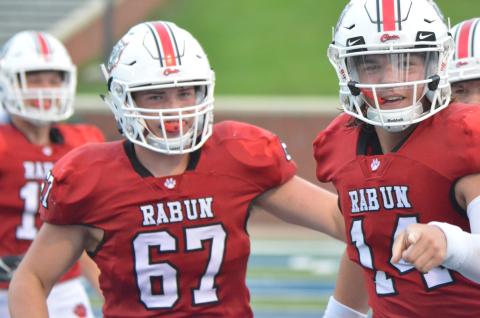 Rabun County offensive lineman Will Hightower (67) and quarterback Gunner Stockton (14) celebrate after a touchdown during the first half against Bremen in the Erk Russell Classic at Georgia Southern’s Paulson Stadium in Statesboro last Saturday night. (Wayne Knuckles/The Clayton Tribune)