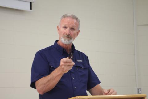 Megan Broome/The Clayton Tribune. Roger Fitzpatrick, site administrator at the Rabun County location of Mountain Education Charter High School, speaks to faculty and staff members for the Rabun County site as well as administrators from the central office and other regions at a celebration event at the Mountain Education Charter High School location in Tiger Monday. 