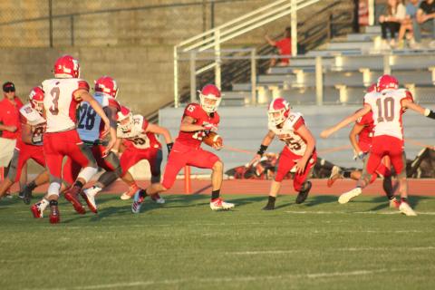 Rabun County wide receiver Sam Adams, middle, looks for  additional yards after making a catch during the first quarter of a preseason game against Franklin (N.C.) at Frank Snyder Memorial Stadium in Tiger last Friday night. (Glendon Poe/The Clayton Tribune)