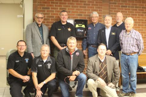 Megan Broome/The Clayton Tribune. The Rotary Club of Clayton has donated four Automated External Defibrillators to Rabun County EMS, two of which replaced old AED’s at the courthouse. Front, from left, Trampes Stancil, EMS captain, Mike Carnes, EMS director, Darrin Giles, county administrator, Tony Penrose; Middle, from left, Tim Ranney, Rotary president, Ray Pagano; Back, from left, Wayne Knuckles, Sheriff Chad Nichols, David Tatum and Matt Mitcham. 