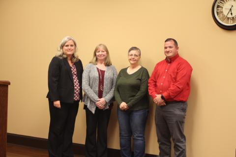 Megan Broome/The Clayton Tribune. Superintendent April Childers, left, Marsha Smith, Donna Headrick, bus driver, and Marty Dixon, transportation director recognize Smith for her 33 years of dedication to Rabun County Schools at the Board of Education meeting on Thursday, Oct. 17. 