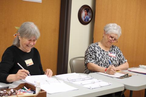 Annabelle Barkman, left, and Jan Timms check people in and verify voter registrations for residents who participate in early voting at the Rabun County Board of Elections Office on Monday. Early voting ends Friday, Nov. 1. 