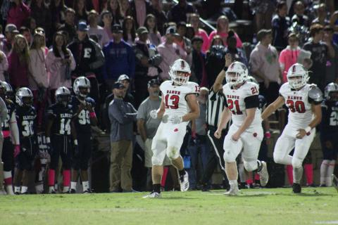 Rabun County linebacker Brody Jarrard (13), defensive lineman Phillip Roberson (21) and linebacker Hoff Windham celebrate after Jarrard’s tackle for a loss during the first half against Elbert County at the Granite Bowl in Elberton last Friday night. (Glendon Poe/The Clayton Tribune)