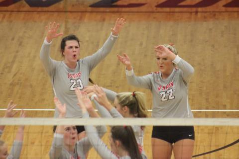 Rabun County’s Destiny Deetz (23), Lexi Crump (22) and teammates celebrate a point against Armuchee during the first round of the GHSA Class A/AA-Public state playoffs in Tiger last Saturday. (Glendon Poe/The Clayton Tribune)