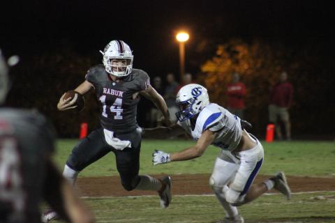Rabun County quarterback Gunner Stockton (14) runs from a Banks County defender during the second half at Frank Snyder Memorial Stadium in Tiger last Friday night. (Glendon Poe/The Clayton Tribune)