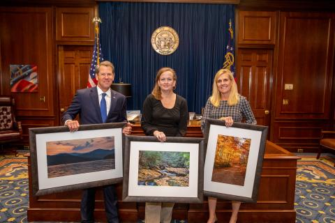 Rabun County photographer Michele Crawford, center, with Gov. and Mrs. Brian Kemp. 