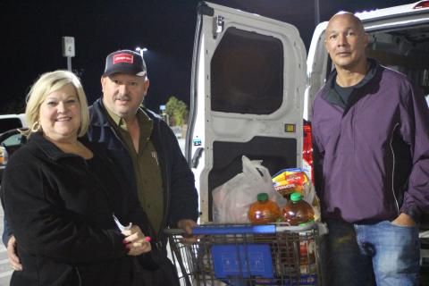 Megan Broome/The Clayton Tribune. Lori Hunter, left, Jeff Hunter of Hunter Electric with Food Bank Manager James Brim.