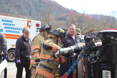 Megan Broome/The Clayton Tribune. Emergency personnel work to free an occupant trapped in a vehicle after it rolled over from a crash in Mountain City on Thursday, Nov. 21 at approximately 12:36 p.m. 