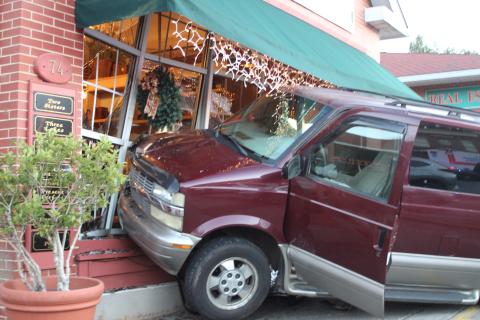 Megan Broome/The Clayton Tribune. A van crashed into the outside of Butler Galleries on Main Street in Clayton on Dec. 11. A Mountain City man was taken to Northeast Georgia Medical Center for treatment as a result of the accident. 
