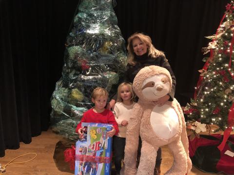 Shelly Lapp and her grand kids, Olivia and Riggs Bakes pack up their Christmas tree after winning the silent auction