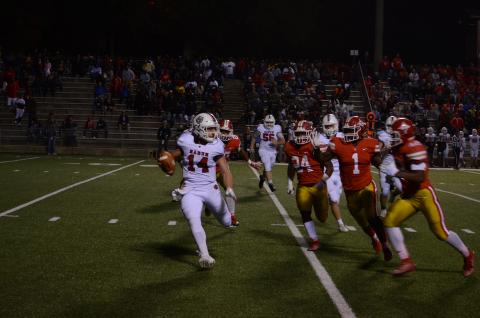 Rabun County quarterback Gunner Stockton (14) tries to avoid oncoming Thomasville defenders Friday night. 