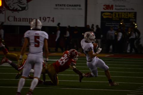 Wayne Knuckles/The Clayton Tribune. Senior Sam Adams (15) eludes a Thomasville defender Friday night. 