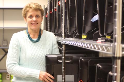 Megan Broome/The Clayton Tribune. Kay Townsend stands in front of the new election equipment that Georgia voters will use when they head to the polls for 2020 elections. 