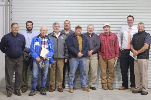 Megan Broome/The Clayton Tribune. Brendan Thompson, general manager for the RCWSA, left, Claude Rickman, Dallas Taylor, Greg Peters, vice-chairman, Kent Woerner, County Commissioner, Roger Mullins, Jerry Krivsky, Jeff Hunter, Brett Cohee, and Darrin Giles, county administrator, stand inside their new office-shop building located on Yorkhouse Rd. in Rabun Gap. 