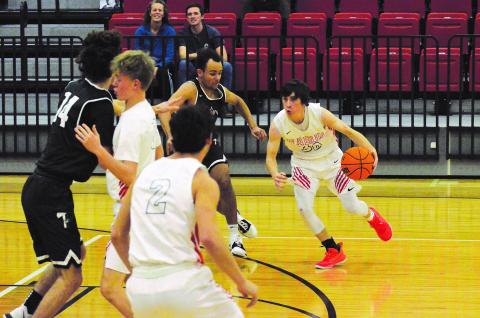 Matthew Osborne/The Northeast Georgian. Rabun County's Grayson Carver (30) looks to drive on Tallulah Falls defender Winston Davis during Friday's game.