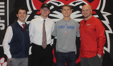 Andy Diffenderfer/The Clayton Tribune From left are Sam Adams, Braxton Hicks, Garrett Bragg and Rabun County High head football coach Jaybo Shaw on National Signing Day Feb. 5 at the school.