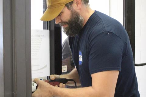 Megan Broome/The Clayton Tribune Steve Moore from R&H Technologies drills a spot for a new keypad where visitors will have to be buzzed-in in order to go inside Clayton City Hall.