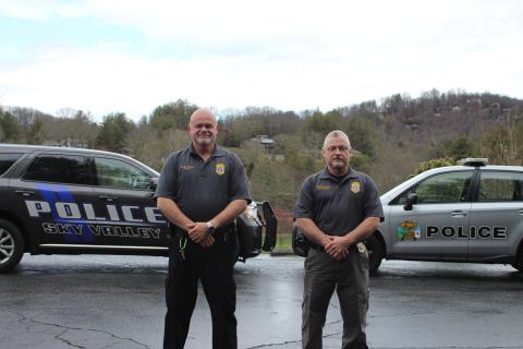 Megan Broome/The Clayton Tribune Sky Valley Chief of Police Vaughn Estes, left, and Lt. David Edwards stand in front of their police vehicles to show the new car the department is getting after council members approved the purchase of a 2020 Dodge Durango and Ram 1500. Shown on the right is one of the Subarus the police officers are currently driving. 
