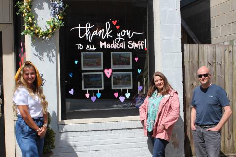 Megan Broome/The Clayton Tribune. Artist Ali Wilkins, left, with Tambrie Kitchens and Jon Barnwell of Re/Max Town and Country of Rabun. 