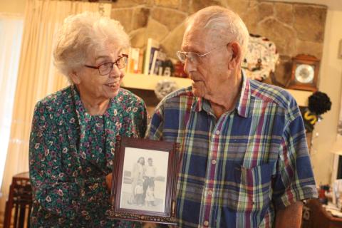 Megan Broome/The Clayton Tribune. Clara and Earl Zoellner of Dillard celebrated their 75th wedding anniversary this week. They were married in 1945 in Clarkesville. Above, the couple holds a picture of themselves with their children, Stanley and Gail, when they were young. 