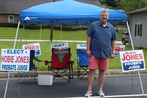 Megan Broome/The Clayton Tribune. Candidate Hobie Jones sets up his tent outside the Civic Center and greets voters as they head to the polls for the primary election on Tuesday. 