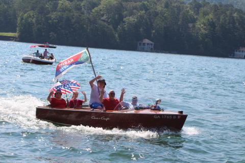 Megan Broome/The Clayton Tribune. The Lake Rabun Association held their annual wooden boat parade on Sunday as part of Fourth of July celebration events to bring the community together.. The wooden boat parade featured rare boats and boats ranging from the 1920s to 1970s.