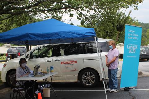 Megan Broome/The Clayton Tribune. Terrell Wilson, right, gets assistance about the 2020 Census from Denica McCurdy, Census Response Representative (CRR) and Mobile Questionnaire Assistant (MQA) for the 2020 Census. A tent was set up at the Rabun County Public Library Monday and Tuesday to help Rabun residents learn more about the 2020 Census and assist with any questions they had. 