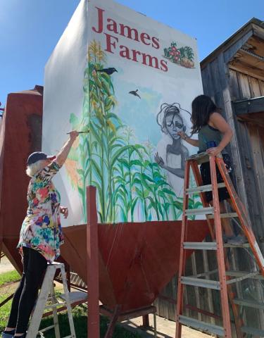 Daniela Cintron/The Clayton Tribune. Lizzy Falcón, right, paints with Diane Rush on one of the spaces outside the new The Lotus Gallery and Art Center, which plans to officially open its doors in 2021 to incite art with local and worldwide artists. 