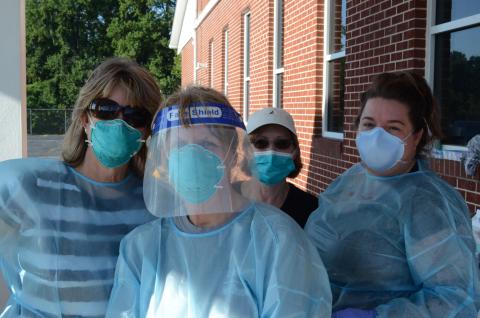 Wayne Knuckles/The Clayton Tribune. Cathy Mummaw, Toshia Hughes and Carmen Rodgers, along with Rabun County Health Department Office Manager Sue Darnell, prepare to administer free COVID-19 tests at Clayton First Baptist Church Tuesday morning. 
