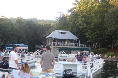 Megan Broome/The Clayton Tribune. Hundreds of boaters turned out for a concert by the Atlanta duo of Banks and Shane Saturday to mark the 100th birthday of Lake Burton.