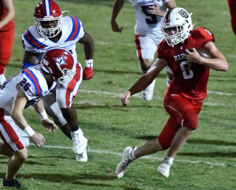 Photo courtesy of Scott Poss. The Wildcats’ Cory Keller swerves to avoid a Jefferson tackler. 