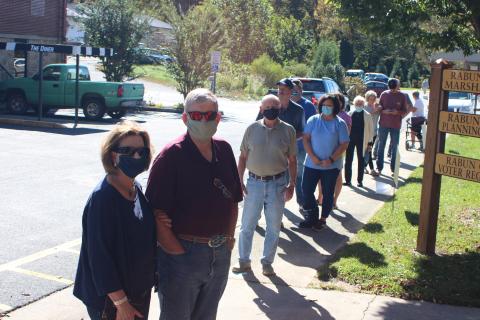 Megan Broome/The Clayton Tribune. Drucilla and Bob Graham (left) stand in a lengthy line at the Rabun County Board of Elections Office Monday to vote early.