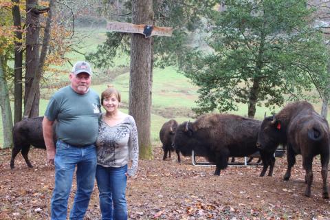 Megan Broome/The Clayton Tribune. Mary Serra and Mike English own nine bison that roam on a 48-acre farm off of Persimmon Rd. Serra named it Tallulah Bison Ranch. Eight of the bison came from Montana and Minnesota. Serra said that owning a herd of bison is something she wanted to check off of her bucket list in her life. 