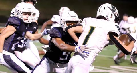 Photos courtesy of Rabun Gap-Nacoochee The Eagles’ Tucker Holloway tries to break free from Charlotte Christian tacklers. 