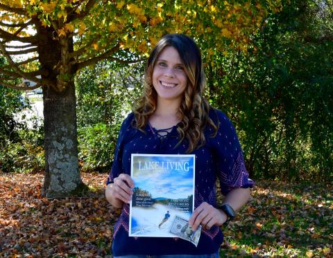 Photo courtesy Kimberly Brown. Heather Conner of Clayton holds a copy of her photograph of a water skier, which graces the cover of the winter 2020 edition of Lake Living magazine. In addition to having her photograph on the magazine's cover, Conner won $100. 