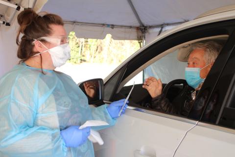 Megan Broome/The Clayton Tribune. Nurse Carmen Rodgers administers a COVID-19 test on Ray Pagano at the drive-thru clinic at the Rabun County Health Department on Tuesday. 