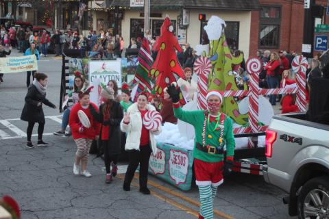 Megan Broome/The Clayton Tribune. Clayton First United Methodist Church was the second place winner in the judging contest for the Clayton Christmas Parade last Saturday with the theme “Jesus is the Sweetest Treat.” Pastor Zack Martin waves at bystanders as the float travels down Main Street. 