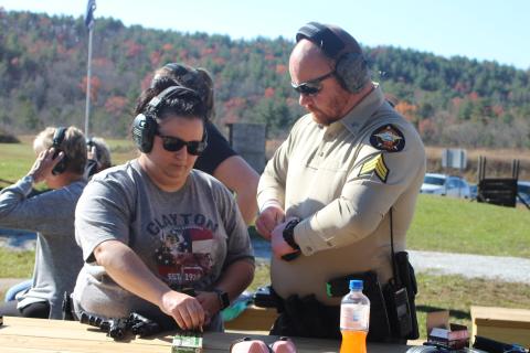 Megan Broome/The Clayton Tribune. Sgt. Riley Owens, right, assists Amber Owens with loading her gun at the Level 3 Firearms Course organized by the Rabun County Sheriff’s Office last weekend. 