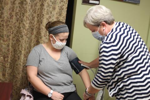 Megan Broome/The Clayton Tribune. Brooke Jones, left, gets her blood pressure taken by new County Nurse Manager Dulene Jones at the Rabun County Health Department. 